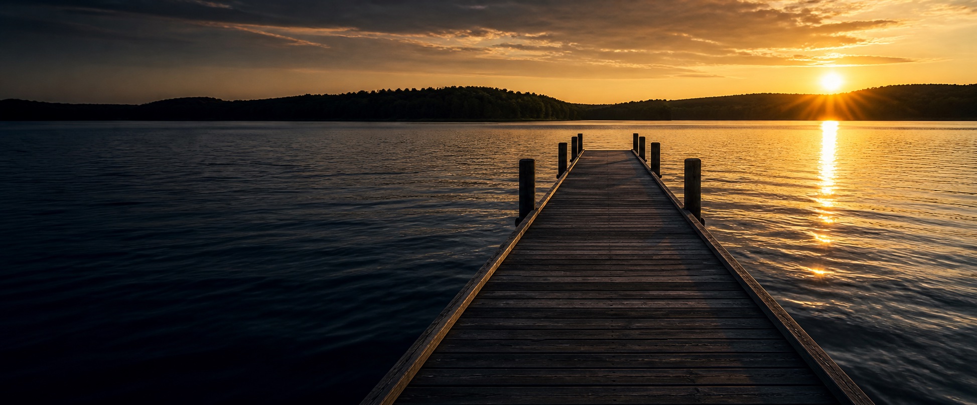 Golden sunset over Grand Lake from a wooden dock